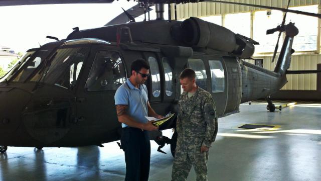 Galyon going over the results of an energy audit of one of the aircraft hangars with Sgt. Linder, the command's Building Energy Manager