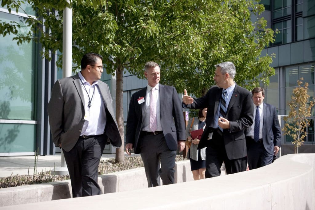 Jeff Rangel, Brocade Director, Corporate Affairs (right), and Victor Garcia, Brocade Director of Facilities (left), speak with Congressman Scott Peters (center) at Brocade corporate headquarters.