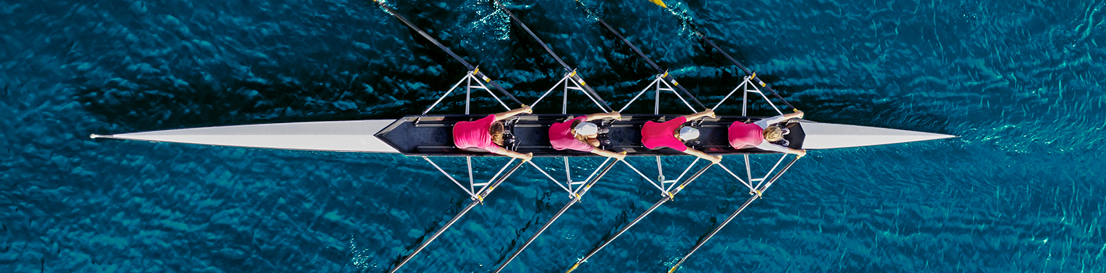 Women's,Rowing,Team,On,Blue,Water,,Top,View