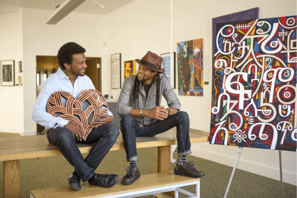 Trevor Parham and Abba Yahudah with their respective artwork, featured at Oakstop.