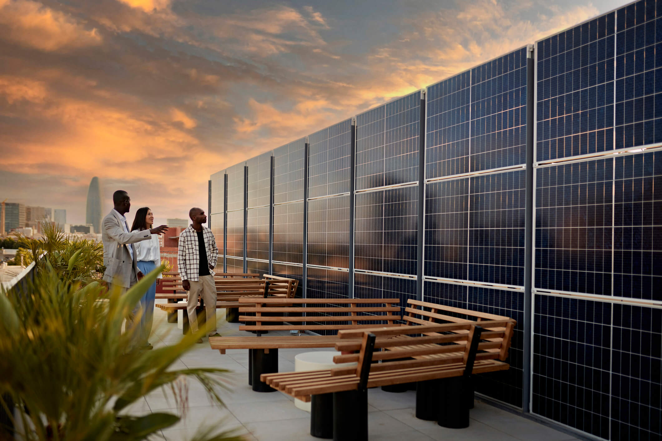 three people looking at solar panels on office building