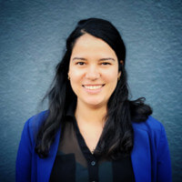 woman with black hair blue jacket