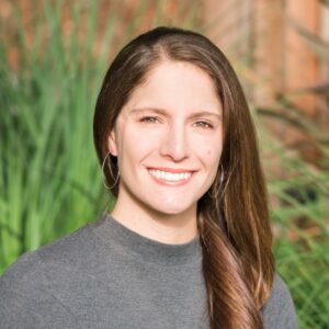 woman with brown hair and grey sweater