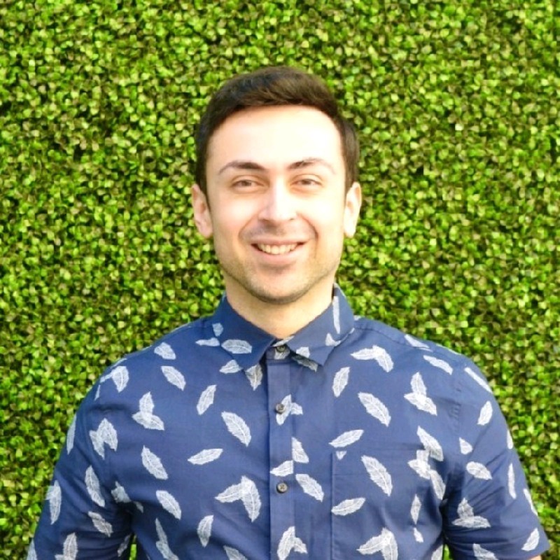 young man with brown hair wearing blue pattern shirt