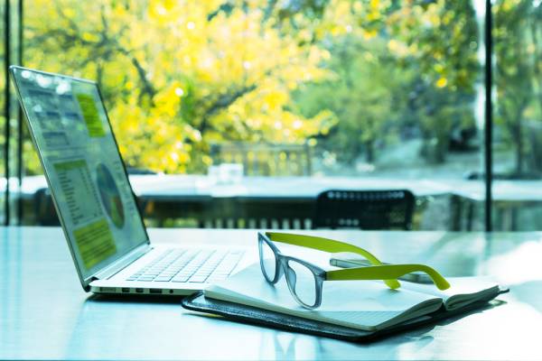 Laptop and glasses on desk